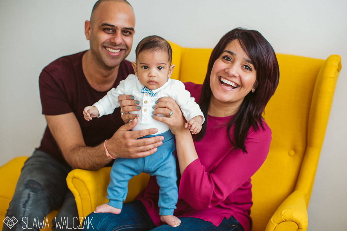 happy family posing for their lifestyle family photography in their london house
