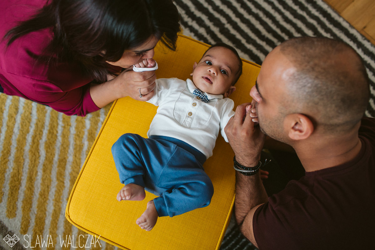 parents kissing their child during a family photography session in London