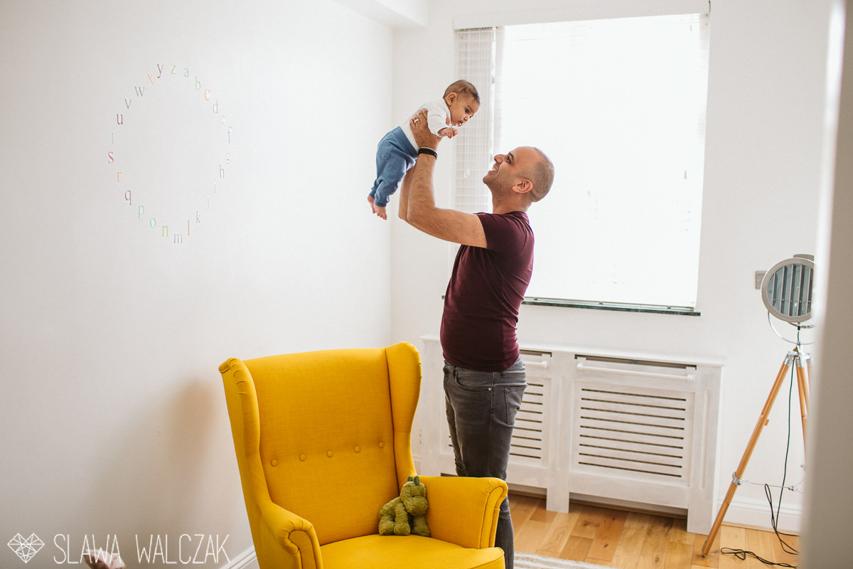 Father playing with his few months old son during a london family photography session