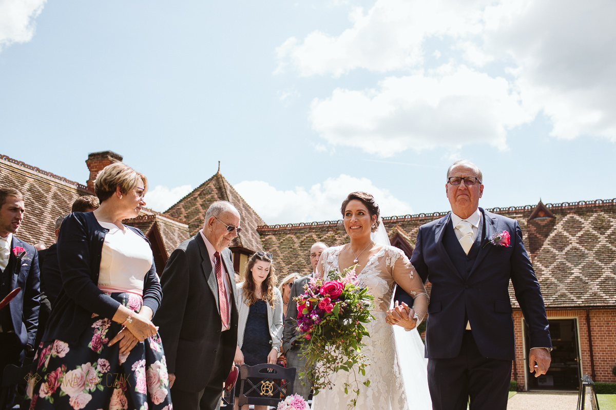 emotional bride being walked down the aisle by her father at the Dairy in Waddesdon