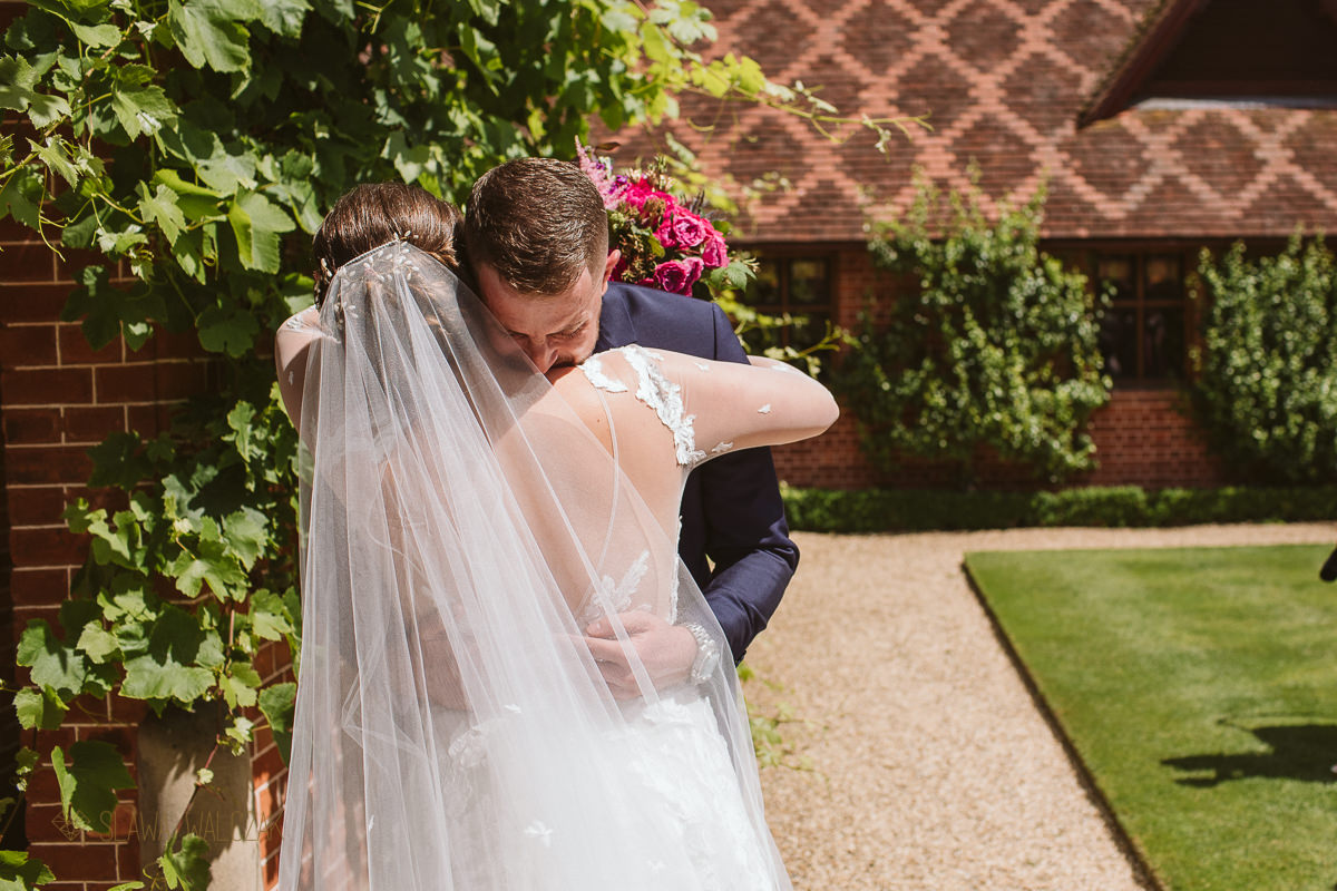 bride and groom hug at an outdoor wedding in the Dairy Waddesdon Manor