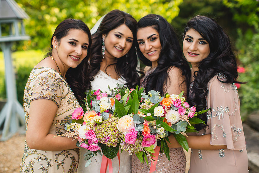 Indian bride and her bridesmaids posing for wedding photos in Surrey
