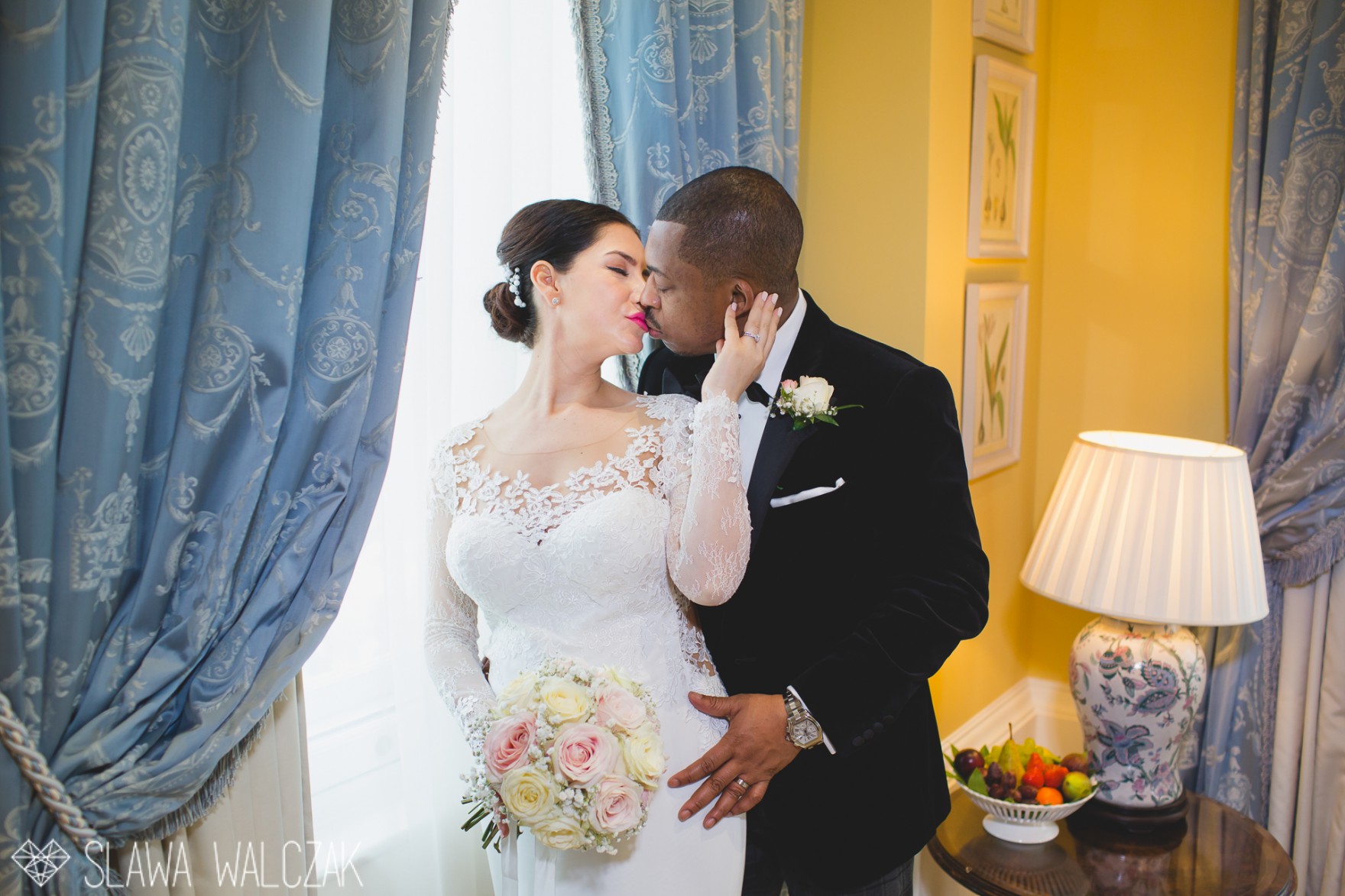 bride and groom kiss affectionately during a photo session in the Lanesborough Hotel