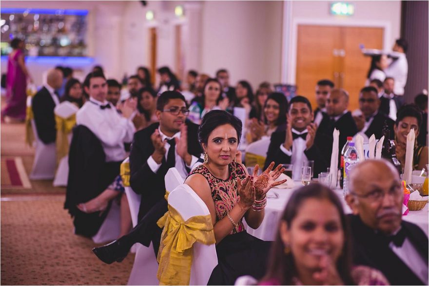 guests clapping at an asian wedding in london