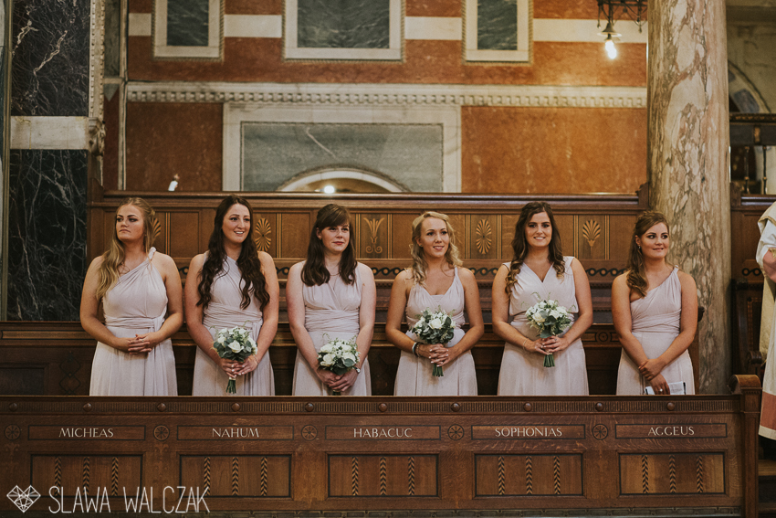 bridesmaids standing at westminster cathedral during a wedding mass