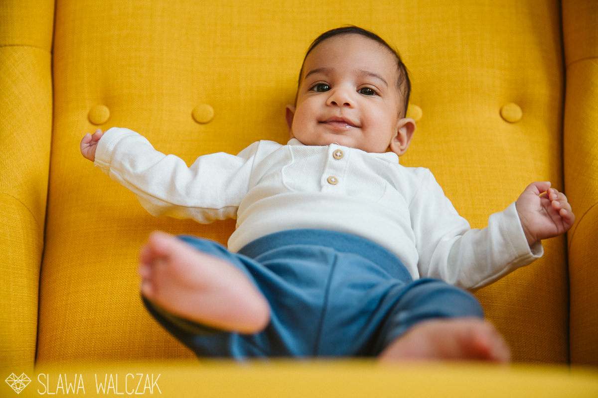  baby smiling while posing for his newborn photograhy in London
