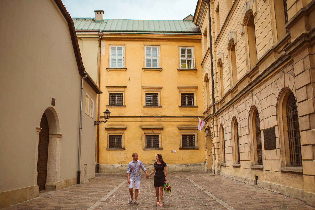 canadian couple posing for their destination engagement photos in Krakow