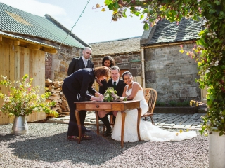 signing of a registry at a scottish wedding in Cockdurno Farmhouse