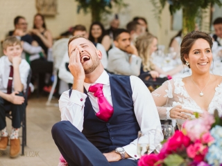 groom laughing during speeches at the Waddesdon Manor Wedding
