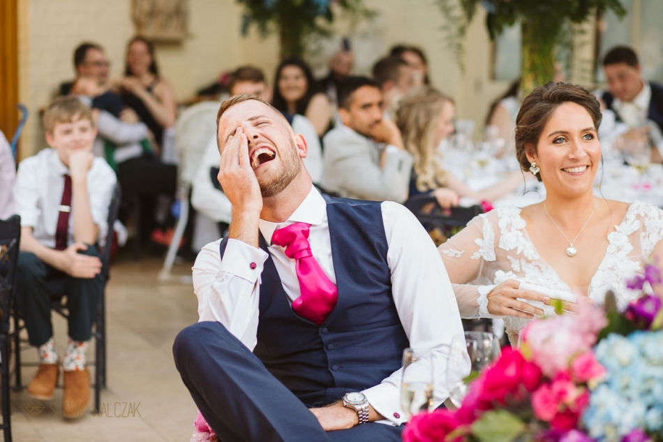 groom laughing during speeches at the Waddesdon Manor Wedding