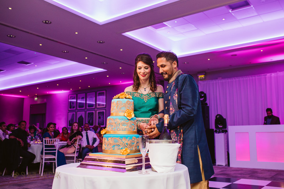 cake cutting at De Vere Beaumont Estate Indian Wedding Photography