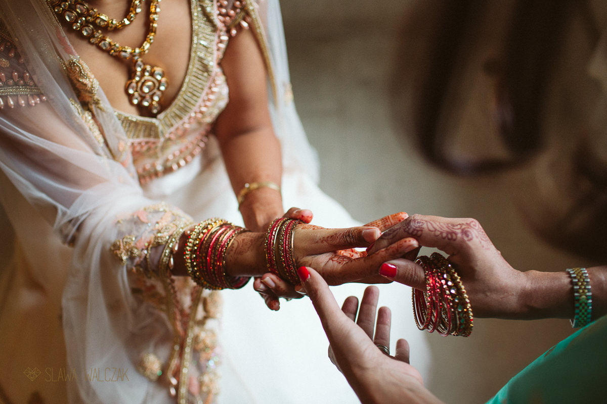 Hindu bride putting up her bangles at a wedding in Chiswick House