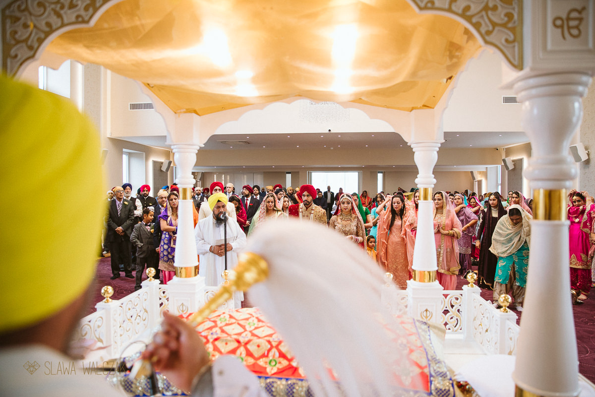 Groom signing a registry during his sikh marriage ceremony