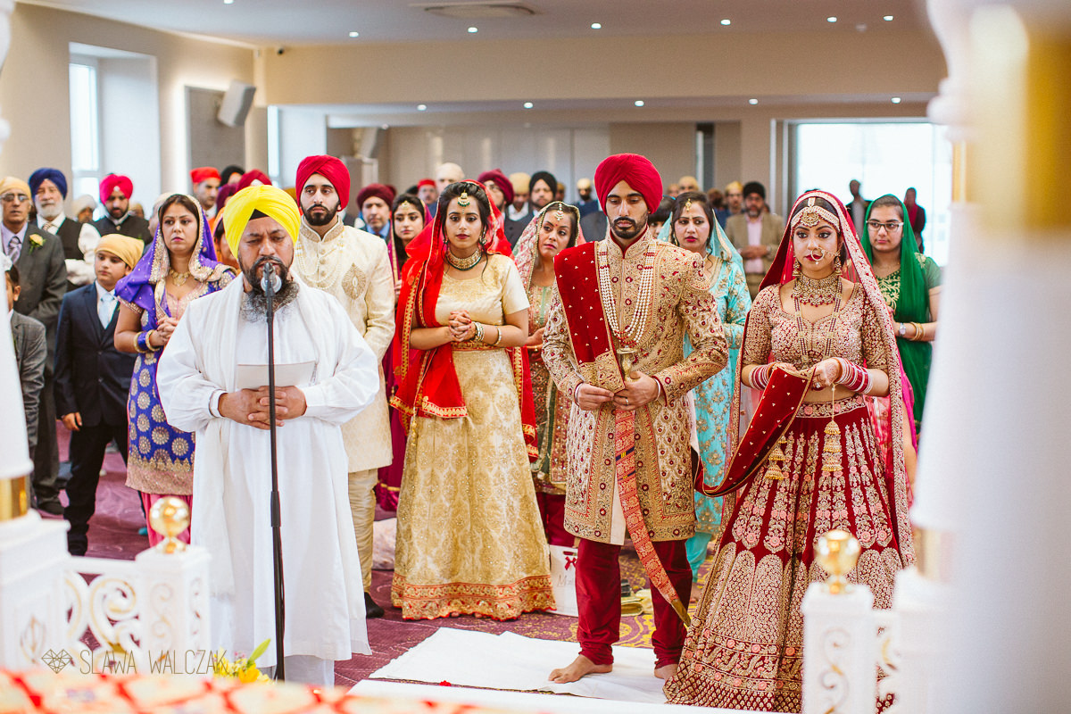 Groom signing a registry during his sikh marriage ceremony
