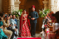 Elegenat Asian Bride being walked down the Aisle by her brother at an Indian Wedding in London