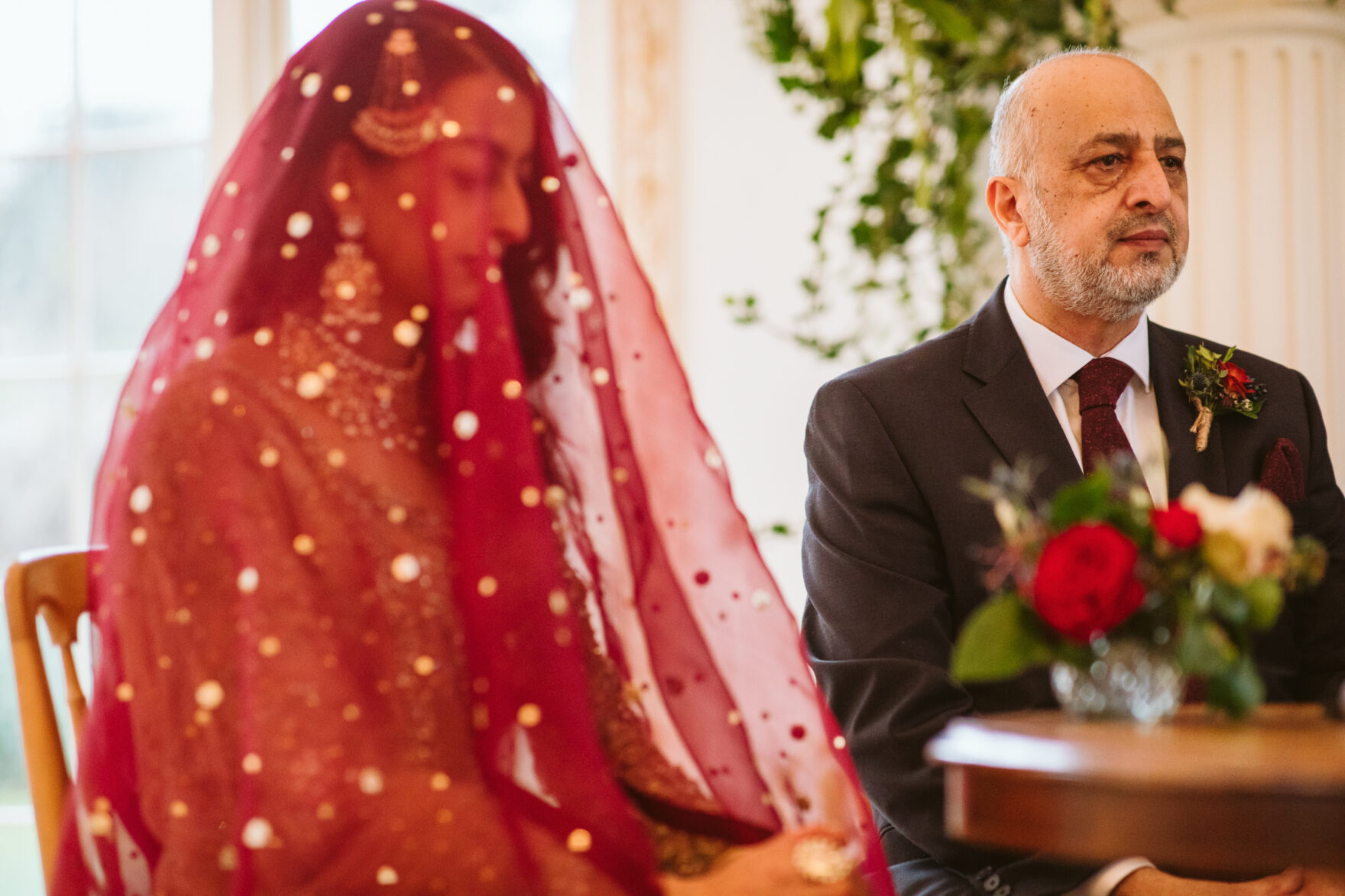 Asian Bride's father praying at a wedding ceremony
