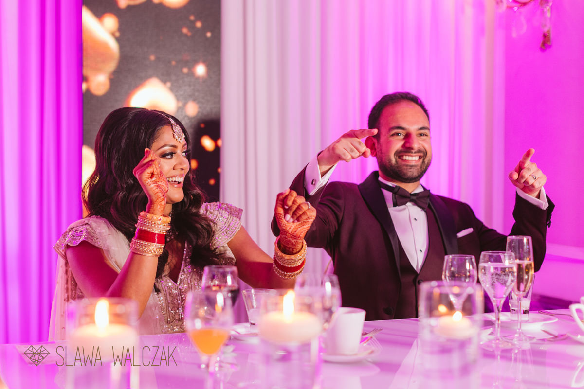 bride laughing during speeches at her wedding in Landmark Hotel London