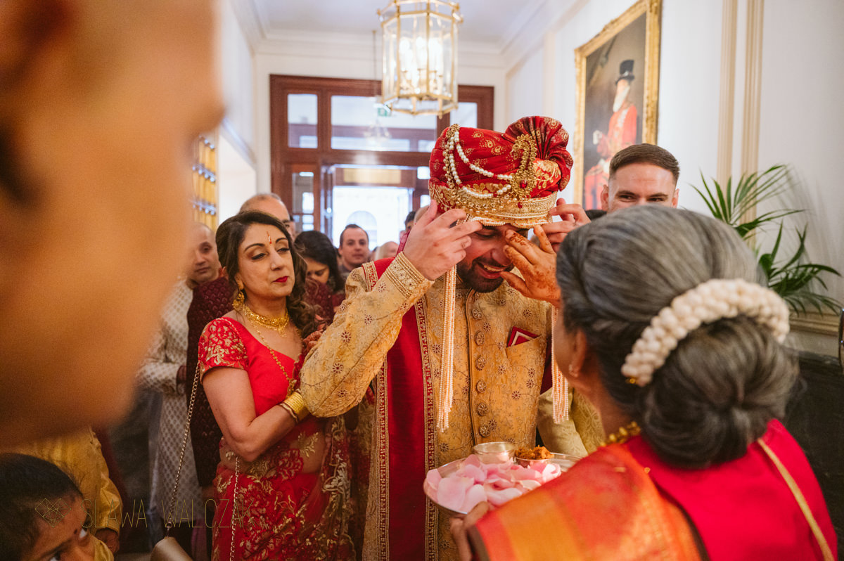 groom is greeted by bride's mum at a wedding in Landmark Hotel