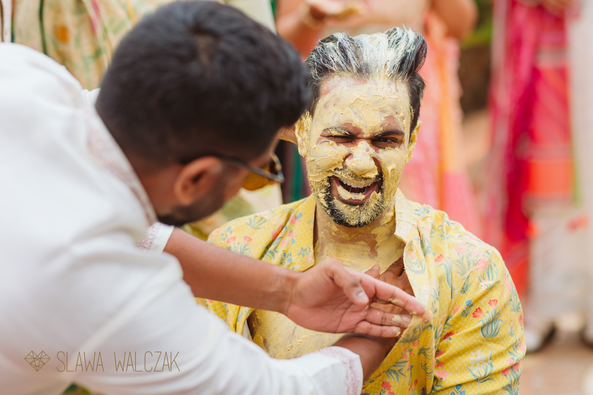 groom getting a beauty treatment during a Haldi ceremony