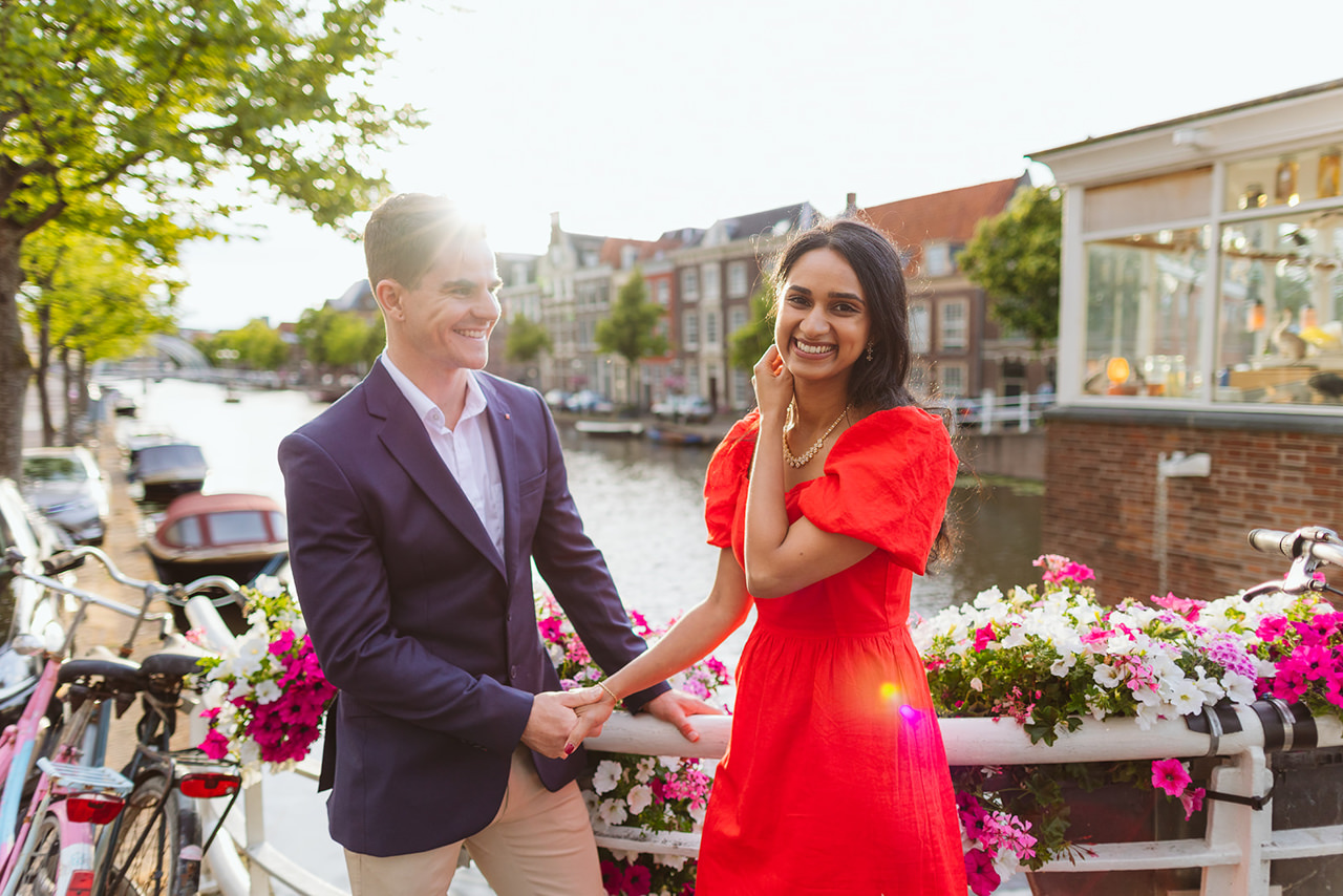 couple posing and giggling during theirs pre wedding engagement photos in Amsterdam
